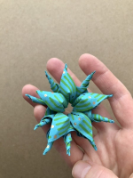 Step 10 medusa kusudama: Attach five units together by curling left-hand and right-hand flaps around each other.