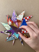 Step 11 starfish mandala: Fold the mandala's points inwards, arranging them in a fan.