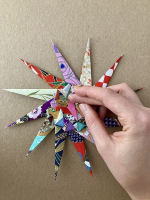 Step 14 starfish mandala: Fold the points into the middle again.