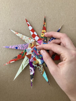 Step 16 starfish mandala: Fold the points into the middle again.