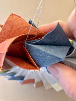 Step 14 16 piece modular pinwheel: Use needle and thread to suspend the model and hang it.